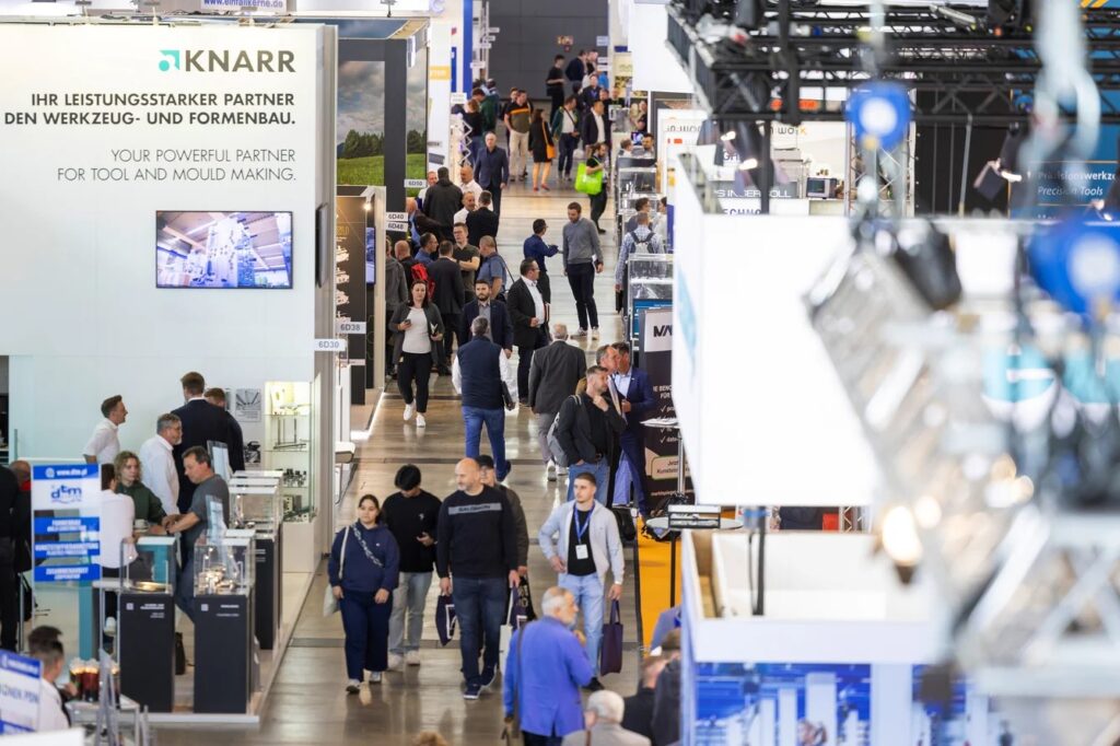 Expo attendees engaging with the Dasyc team during Moulding Expo 2025 in Stuttgart.